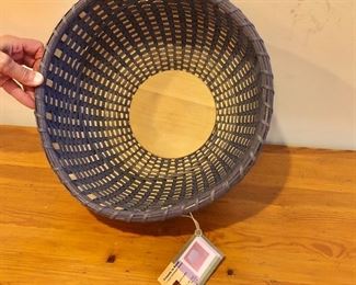 $75 Woven basket with label. 13" diam, 7" H.    
