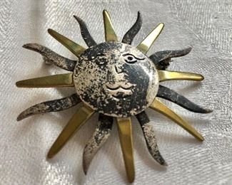 $30 Sun pin pendant with gold and silver tone rays 