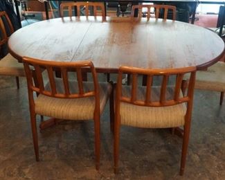 Mid-Century table By CJ Rosegaarden with two leaves and 6 Danish Teak Mid-Century Niels Moller chairs Model 83,  one chair has a stain on the fabric. These are a must-see!!!!