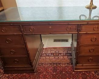 Solid wood desk with bamboo accents, leather inlays, and glass top