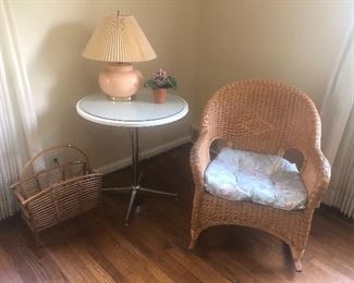 Wicker rocker, side chrome table, rattan basket and lamp