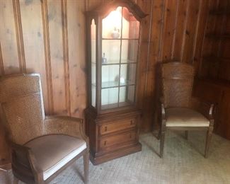 Lit curio cabinet and armchairs with dining room table