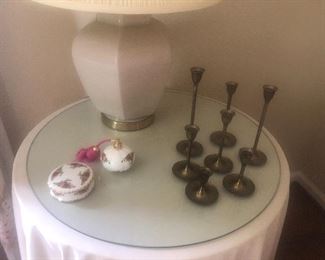 Brass candleholders Fitz and Floyd perfume spray bottle and small covered dish, round glass top table and ceramic lamp
