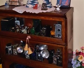 Vintage camera collection in antique barrister's cabinet