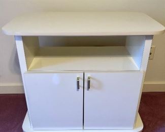 Pretty, ivory colored tv stand with two interior shelves. On Casters for easy moving. Gloss finish. 