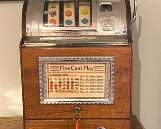 Jennings Operators Bell Five Cent Slot Machine for hours of home entertainment. Comes with they and is in working order. Features quartersawn oak case with gooseneck coin receiver. 

Measures 15" w x 26" h x 14" d 