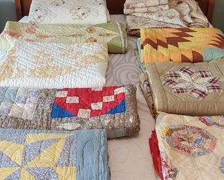 SEVERAL vintage handsewn quilts