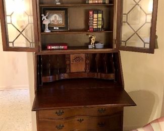 Mahogany Governor Winthrop secretary with key. Drop front opens to desk, cubbies, and hidden compartments. Glass front bookshelf over desk. Lovely condition.