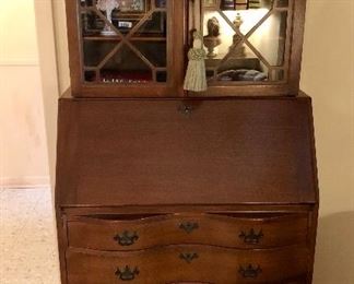 Mahogany Governor Winthrop secretary with key. Drop front opens to desk, cubbies, and hidden compartments. Glass front bookshelf over desk. Lovely condition.