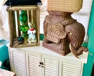 Small wooden cupboard, antique wooden crate, wicker elephant stand, woven basket, tin wood holder