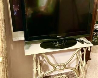 Treadle sewing machine base (iron) w/ detached marble top, 2 flatscreen TV's w/ remotes