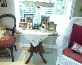 . . . a Victorian lamp table with lamp and needle point chair.