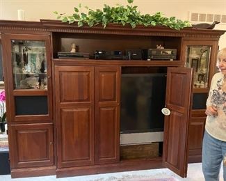 . . . a very nice wall unit filled with treasures, a huge TV, and stereo components