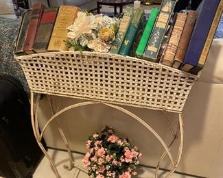 . . . a wrought-iron plant stand being used as a book shelf -- clever