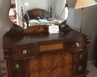 Unique-shaped 3-drawer dresser with shell-motif mirror. 50"W x 22.5"D x 35"H.