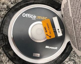 Vintage Apple Mac Clamshell laptop with accessories.