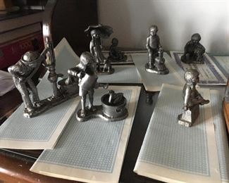 About 40 Michael Ricker pewter figurines with certificates of title.