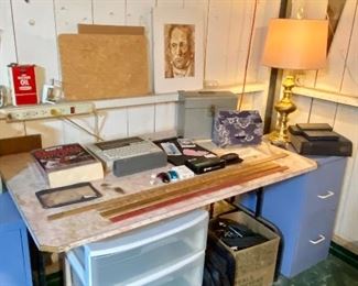Office desk area in basement with file cabinets.