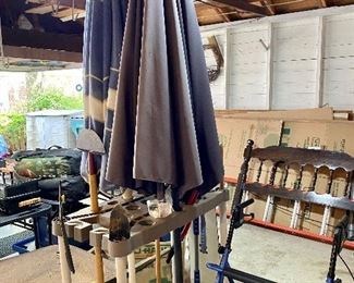 Two patio umbrellas, garden tool holder.