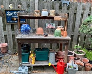 Planting bench, watering cans & planters.