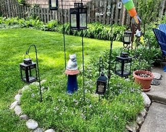 Garden lanterns & concrete figures.