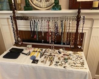 Table full of costume jewelry and watches.