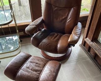 Tobacco colored Stressless chair with ottoman.