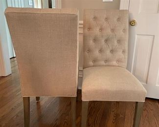 Two Restoration Hardware tufted back side chairs upholstered in oatmeal-color linen fabric. Photo 1 of 2