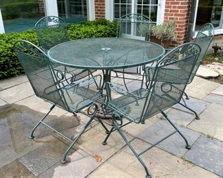 Vintage Woodward Wrought Iron Dining Table with 6 (5 shown) Spring Coil Chairs.