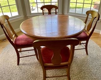 Round table w/ 4 chairs 

Braided round rug 99” diameter 
