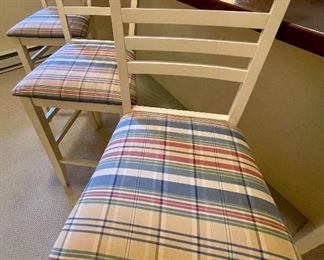3 white counter stools with plaid seats