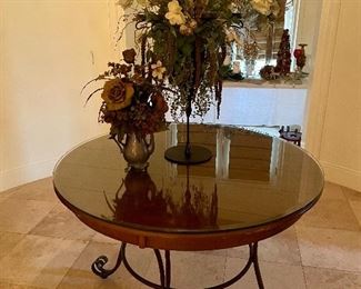 Center table with glass top and iron base, floral arrangements