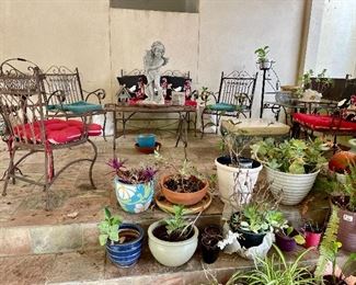 plants, pots, ornate metal patio chairs and coffee table