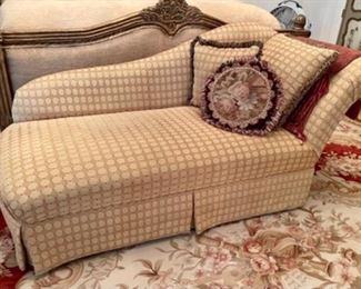 gold upholstered chaise lounge, needlepoint pillows, large needlepoint rugs
