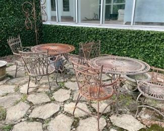 several metal patio chairs and tables