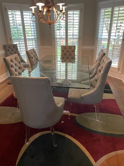 Beautiful glass top acrylic base and leather chairs.