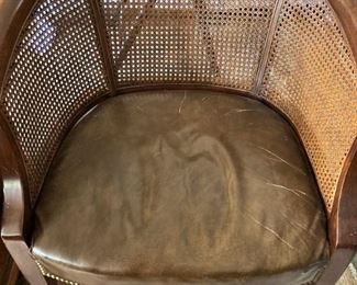 One of two leather seat/cane back chairs