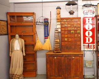 Victorian dress, stacked bookcase, brooms, seed cabinet, bag rack, advertising signs, etc.