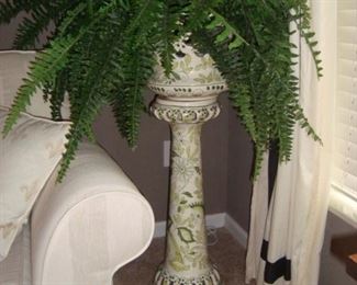 Ceramic pedestal and faux plant.
