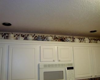 Some of the teapots above kitchen cupboard.