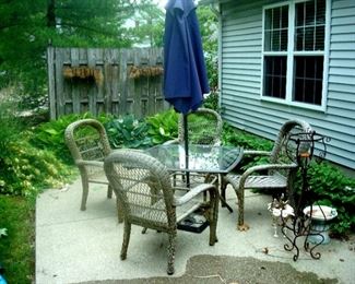 Wicker style reinforced fibre patio set with table, four chairs, umbrella, & umbrella stand. also a bird bath plant holder and metal sculpture.