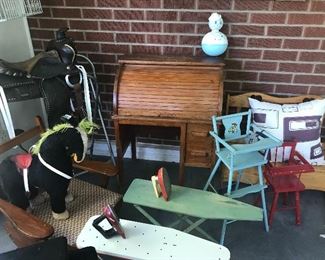 Antique and vintage toy ironing boards with irons, children's toy bench, Antique children's saddle ( missing 1 stirrup) children's rocking chair. ALL in excellent condition