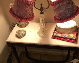 lamp, marble top table, heart box, books