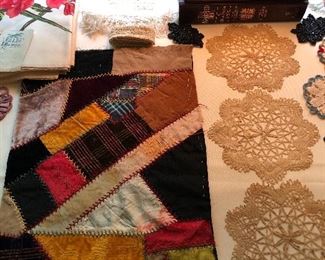 crazy quilt piece, doilies, books, vintage tablecloth