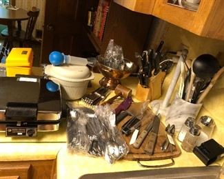 waffle iron, nordick ware, silverware, baster, recipe box, copper colander, salt and pepper shakers,utensil holder, knife block