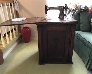 antique sewing machine in square cabinet, makes a beautiful end table when fold up, lg vase,