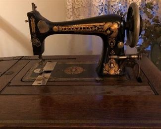 antique sewing machine in cabinet beautiful!