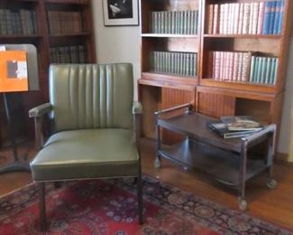 mid-century chair w/ bookcases and lots of books