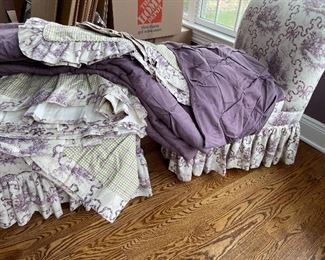 Custom Toile roll back chair and ottoman with matching queen bed skirt,  shams, and two Austrian shades
Accompanied by a solid purple comforter 
