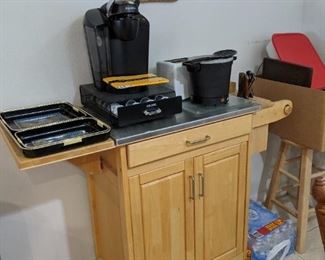 neat kitchen island with steel clad top, knife rack, paper towel holder built in